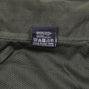Care label inside MIL-TEC Flecktarn softshell jacket showing polyester material and washing instructions