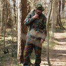 Man wearing original Belgian army M90 jigsaw camouflage military combat field pants in a forest setting