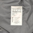 Close-up of a label on waterproof British Royal Air Force wet weather trousers showing size and care instructions.