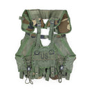 Original U.S. Military tactical combat vest in woodland camo with multiple magazine and grenade pouches, adjustable fit.