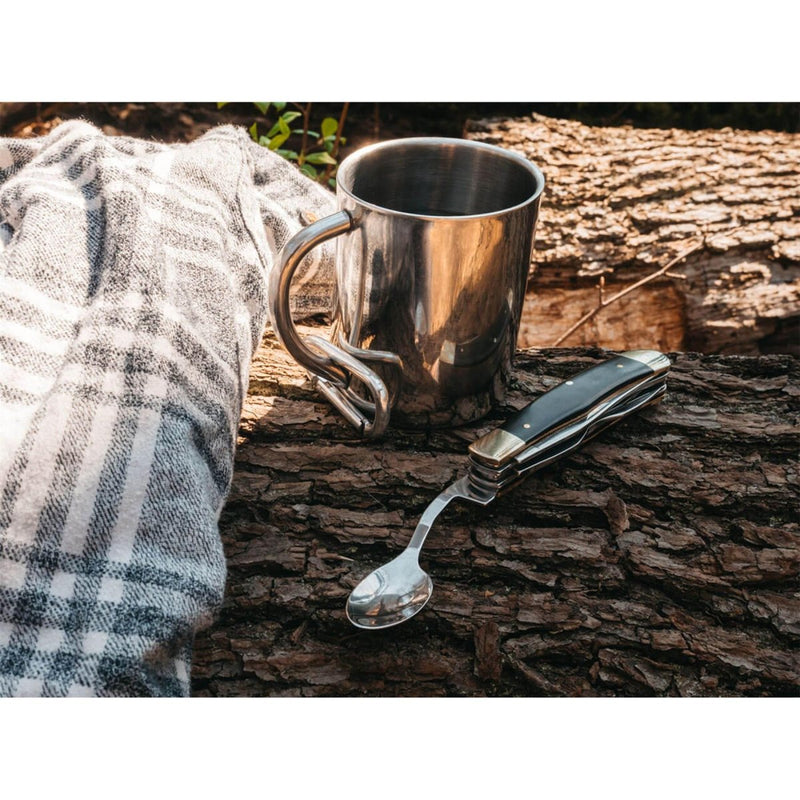 BOKER Bon Appetite pocket cutlery set with wooden handle and 440A steel spoon next to metal camping mug on wood.