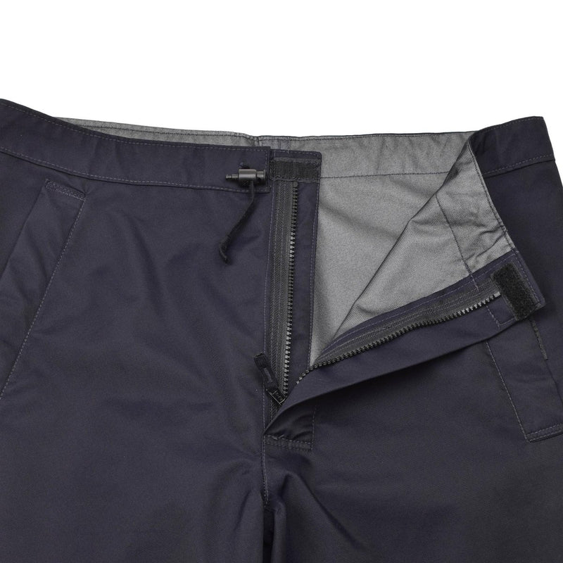 Close-up of navy blue Genuine British police waterproof rain trousers with zipper and adjustable waist tabs open