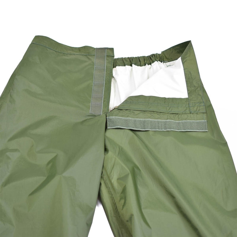 Vintage genuine Danish army olive waterproof rain trousers with hook and loop front closure and polyamide fabric.