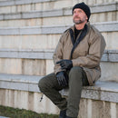 handsome guy sitting with Dutch military parka and feeling cozy