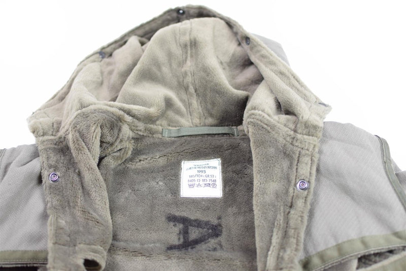 Close-up of Genuine German army parka liner with soft winter faux fur lining and label inside the hood area.