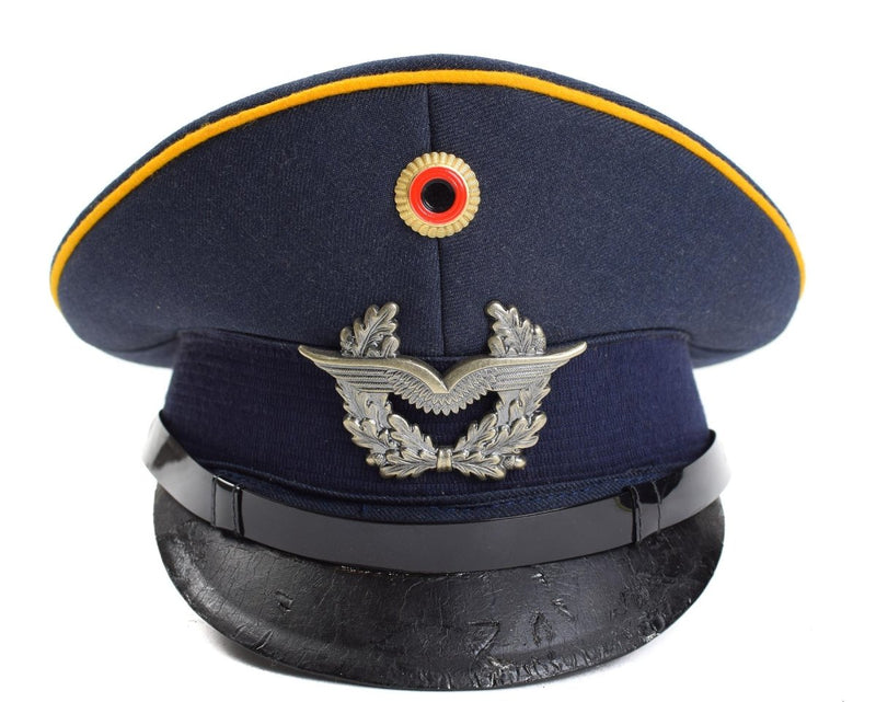 Vintage German Luftwaffe Air Forces peaked visor cap in blue with military insignia and black leather visor