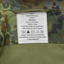 Close-up of care label on German Flecktarn camo military field shirt for women made of cotton and polyester blend