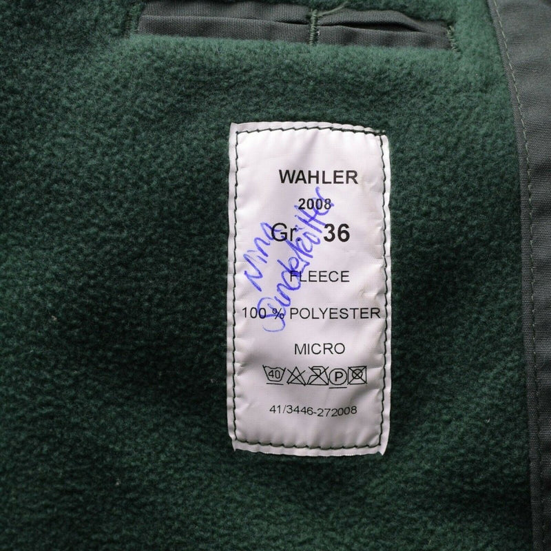 Close-up of green fleece police jacket lining with WAHLER label, size 36, 100% polyester micro fabric inner tag.