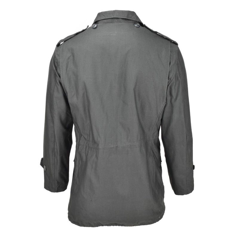 Back view of a genuine Greek Army M65 unlined grey military surplus jacket with buttoned cuffs and epaulets.