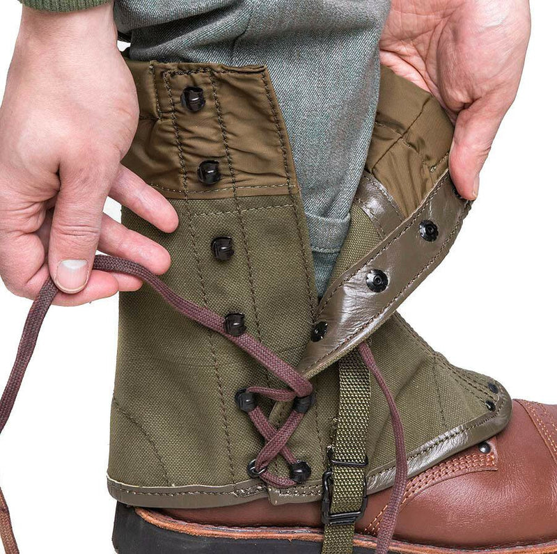 Close-up of vintage olive Italian army canvas gaiters being secured over brown leather boots.