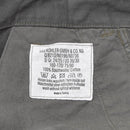 Close-up of Leo Kohler combat military pants cotton fabric care label with size and washing instructions.