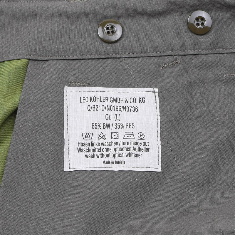 Close-up of Leo Köhler knee-length shorts label showing size, fabric composition, washing instructions, and origin.