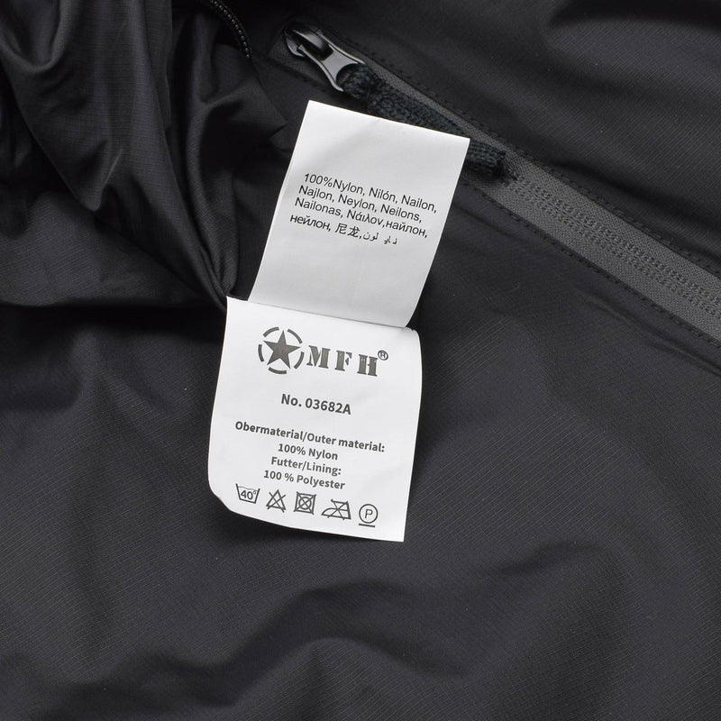 Close-up of MFH thermal jacket label showing 100% nylon outer material and polyester lining with care instructions.
