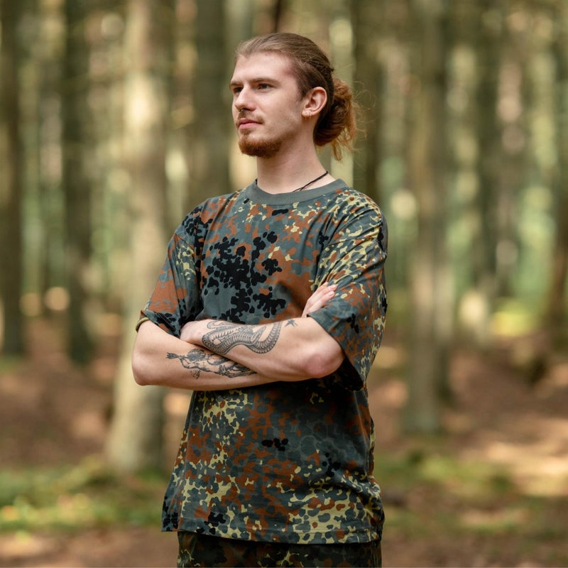 Man wearing MFH U.S. military-style BW camouflage lightweight breathable sportswear t-shirt in forest setting