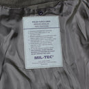 Close-up of Mil-Tec polar fleece liner label inside waterproof German army parka jacket showing care instructions.