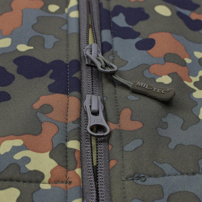 Close-up of MIL-TEC Flecktarn camo softshell jacket zipper and fabric detail for outdoor use.