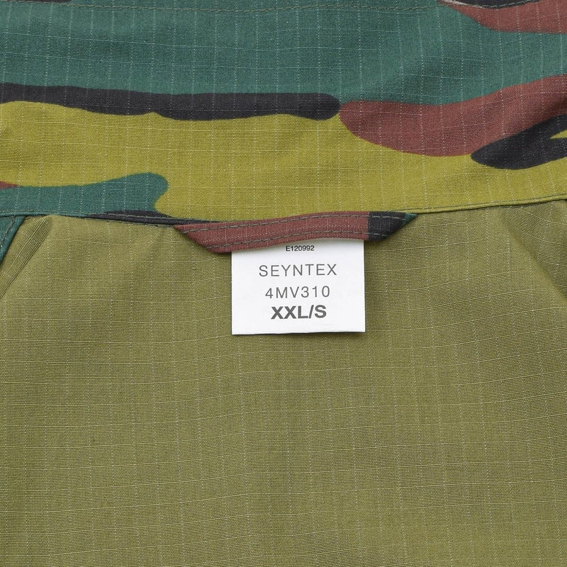 Close-up of Original Belgian Army field combat shirt label sewn on jigsaw camouflage ripstop fabric in XXL size