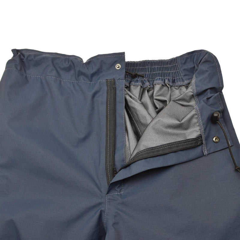 Close-up of blue waterproof British Royal Air Force mens rain trousers showing inner lining and zipper details.