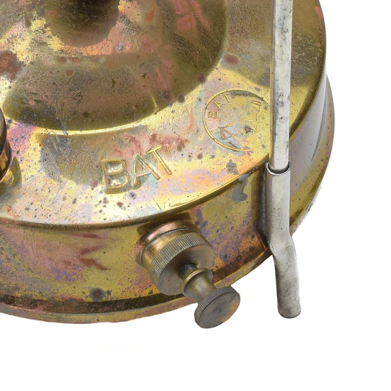 Close-up of vintage Czech military Meva liquid fuel camping stove burner with metal fuel knob and brass finish.
