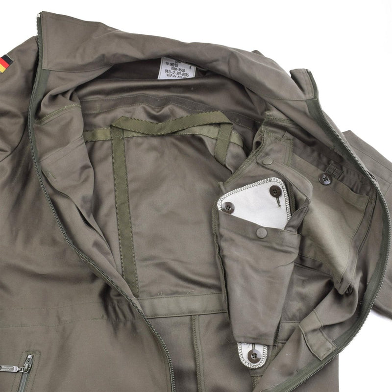 Inside view of original German Army olive green warm winter coverall with zipped pockets and adjustable waist straps