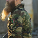 Side view of man wearing lightweight woodland camo Italian military combat jacket with Italia patch on arm