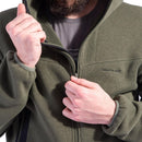 Close-up of a person zipping up an olive green Pentagon Falcon Pro tactical knitted fleece sweater with hood and elastic cuffs.