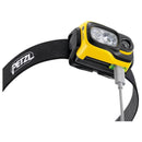 Yellow PETZL Swift RL rechargeable headlamp with black adjustable strap and USB charging cable attached
