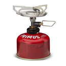 Compact Primus Essential Trail DUO camping stove with fuel canister for quick outdoor cooking and boiling.