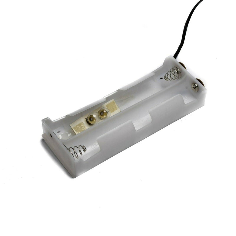 White electronic component with gold contacts on a white background