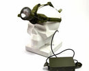 Green headlamp on a white skull with power bank attached, on a white background